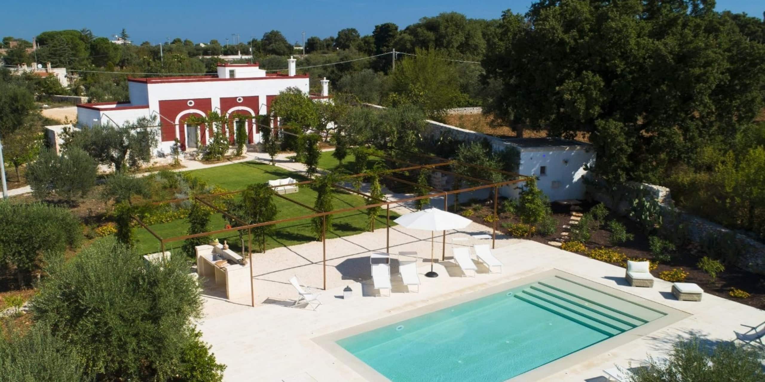 Aerial view of the property: the masseria, the pool and the olive garden