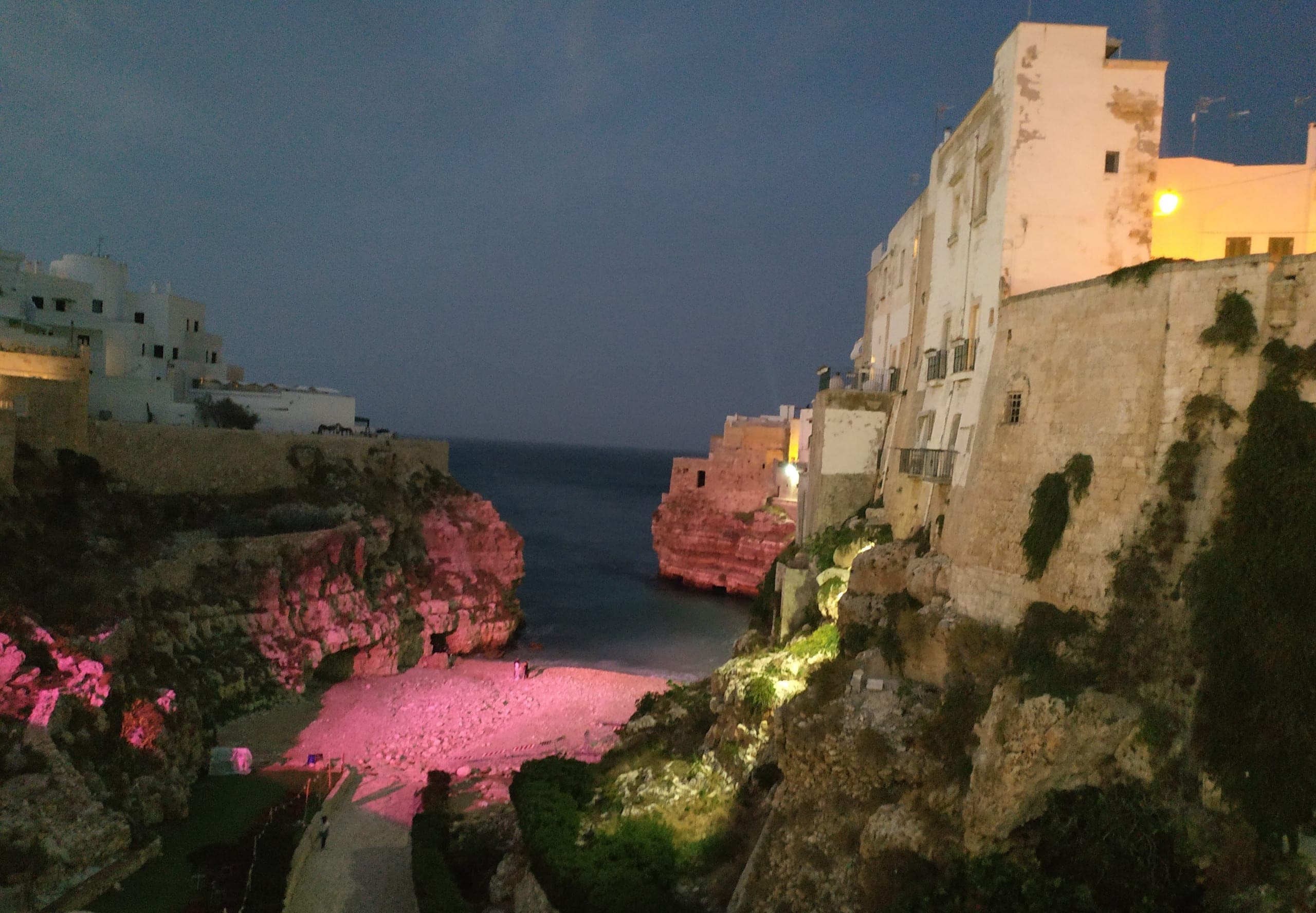 The Lama Monachile cove in Polignano a Mare, lit up after nightfall